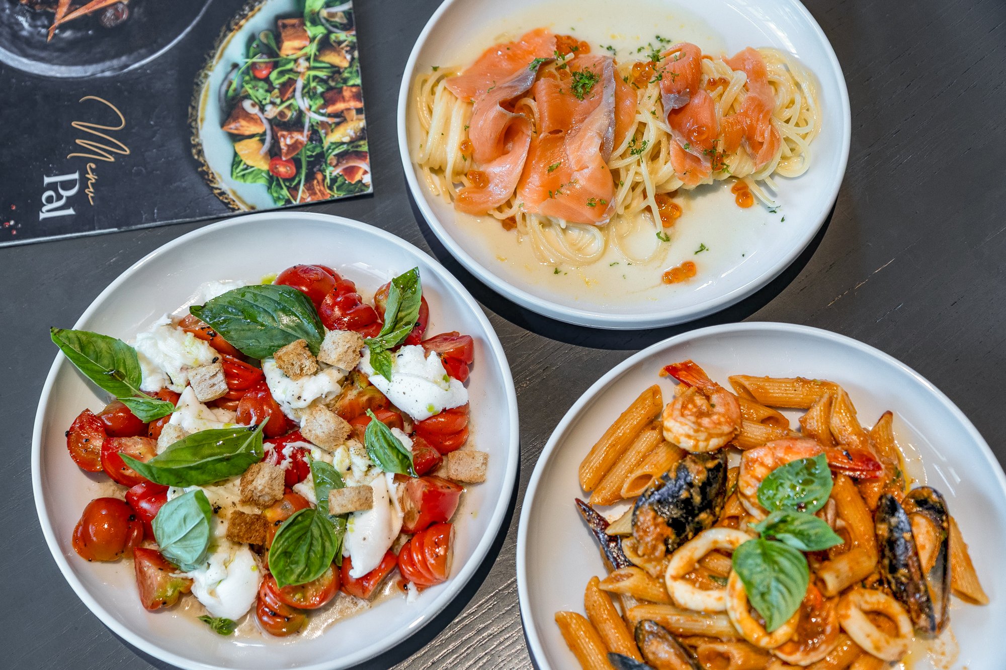 Signature dishes of Caprese, salmon pasta and seafood penne at Pal Cafe