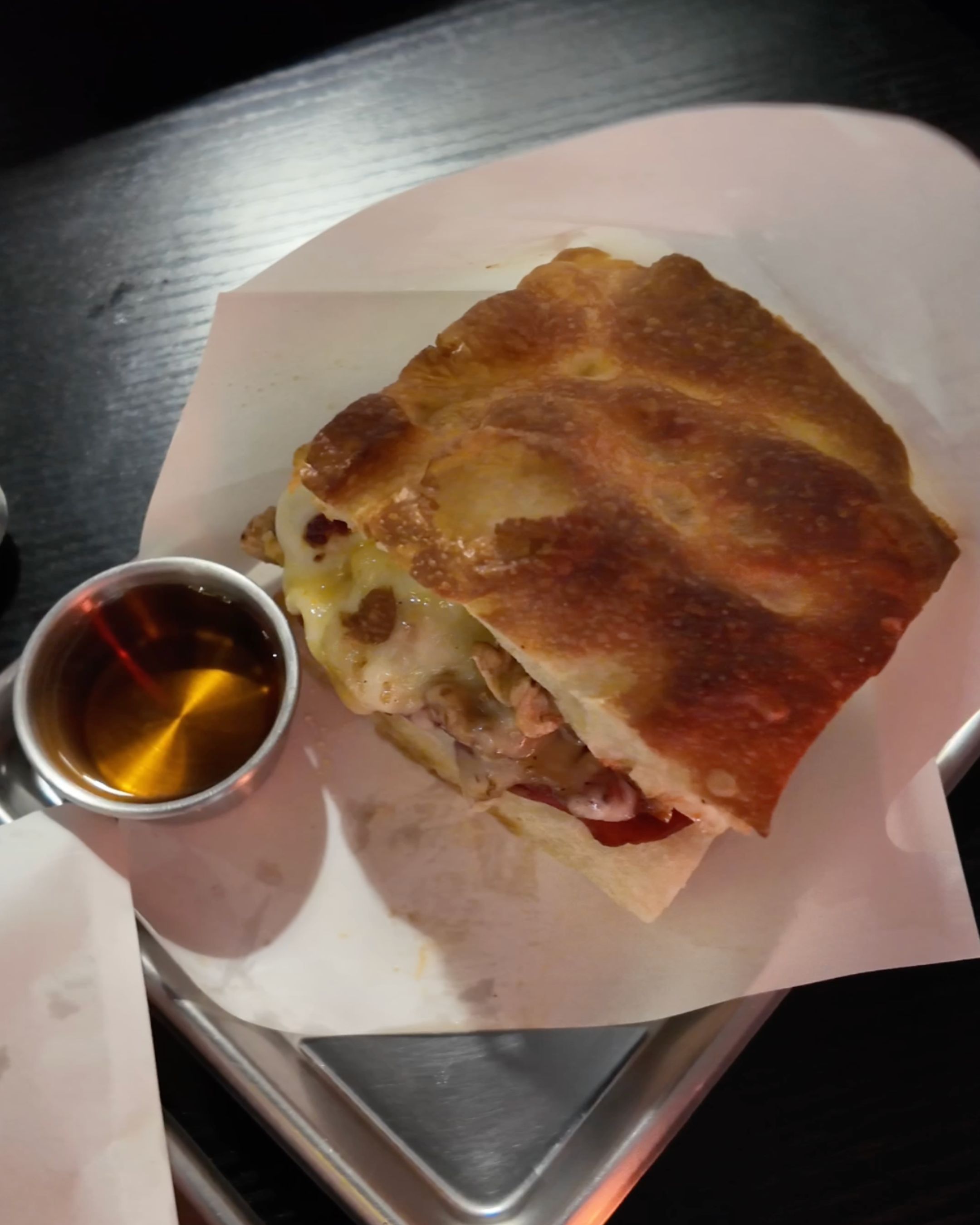Enjoy a crispy sandwich served with a delicious sauce at Brunch of Idiot.