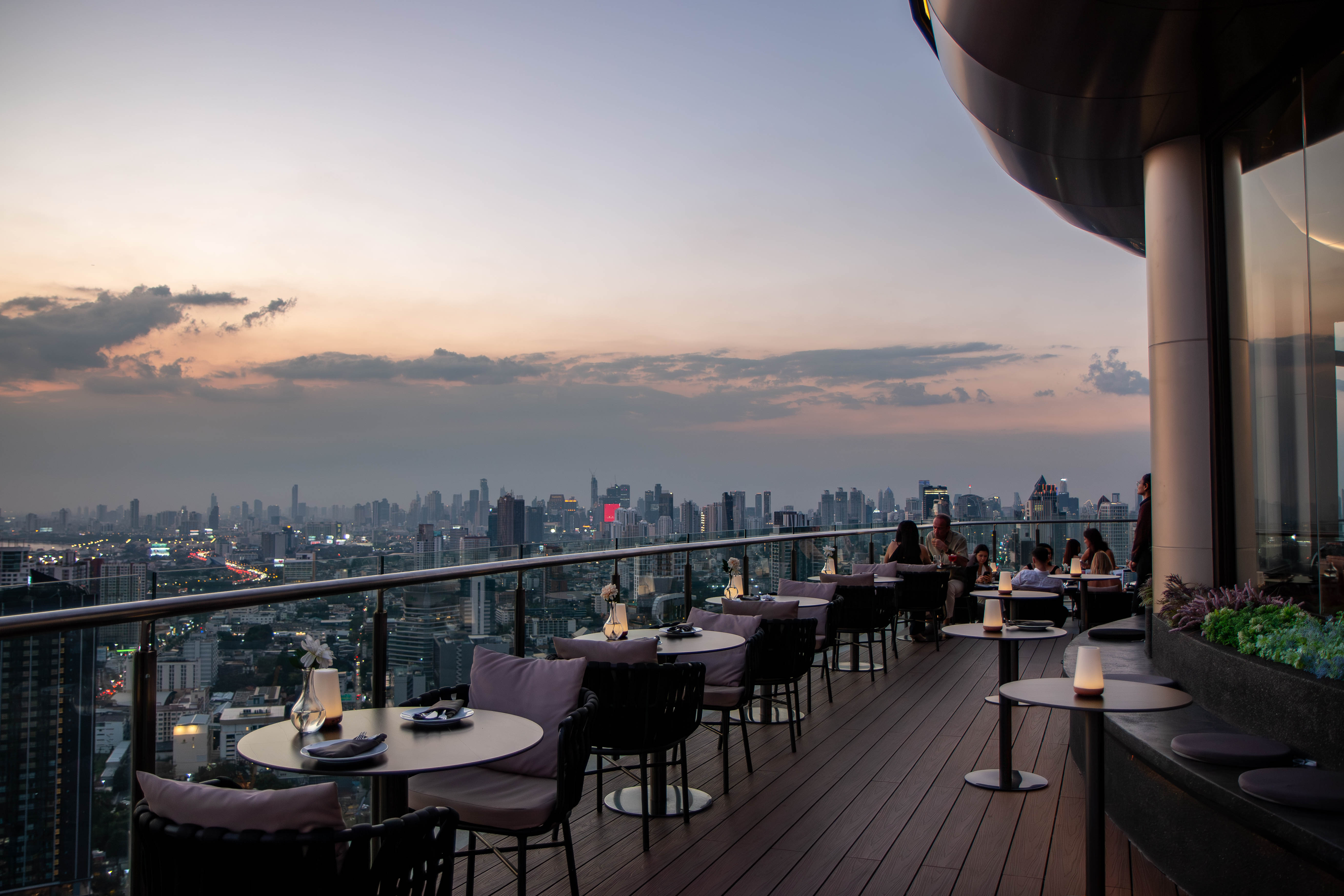 A romantic outdoor atmosphere with breathtaking views from above, offering the perfect setting to sit back, relax, and admire the stunning city skyline.