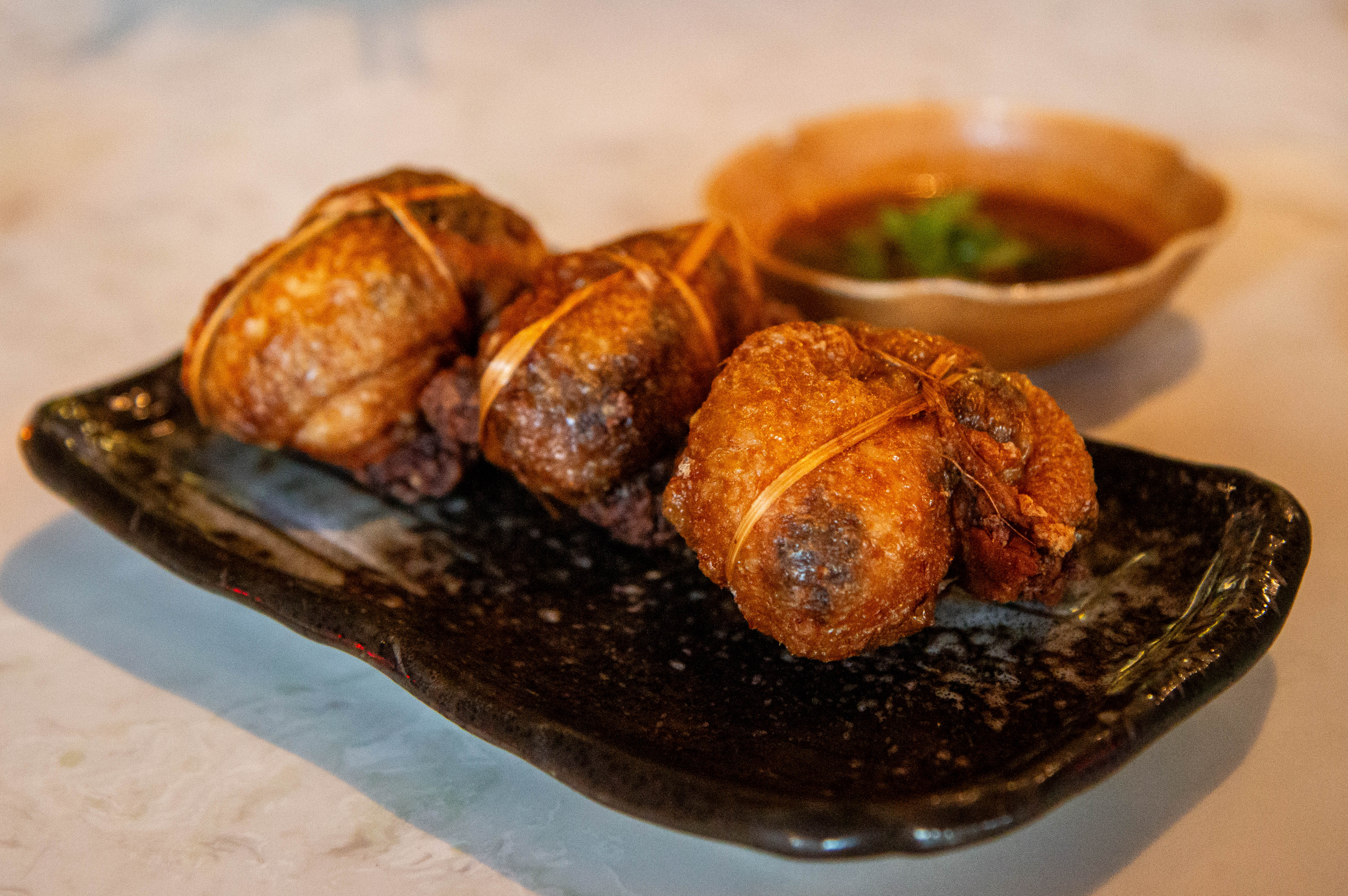 "Chicken in Trouble" – Deep-fried deboned chicken wings stuffed with black sticky rice, served at Namsu Shan Izakaya.