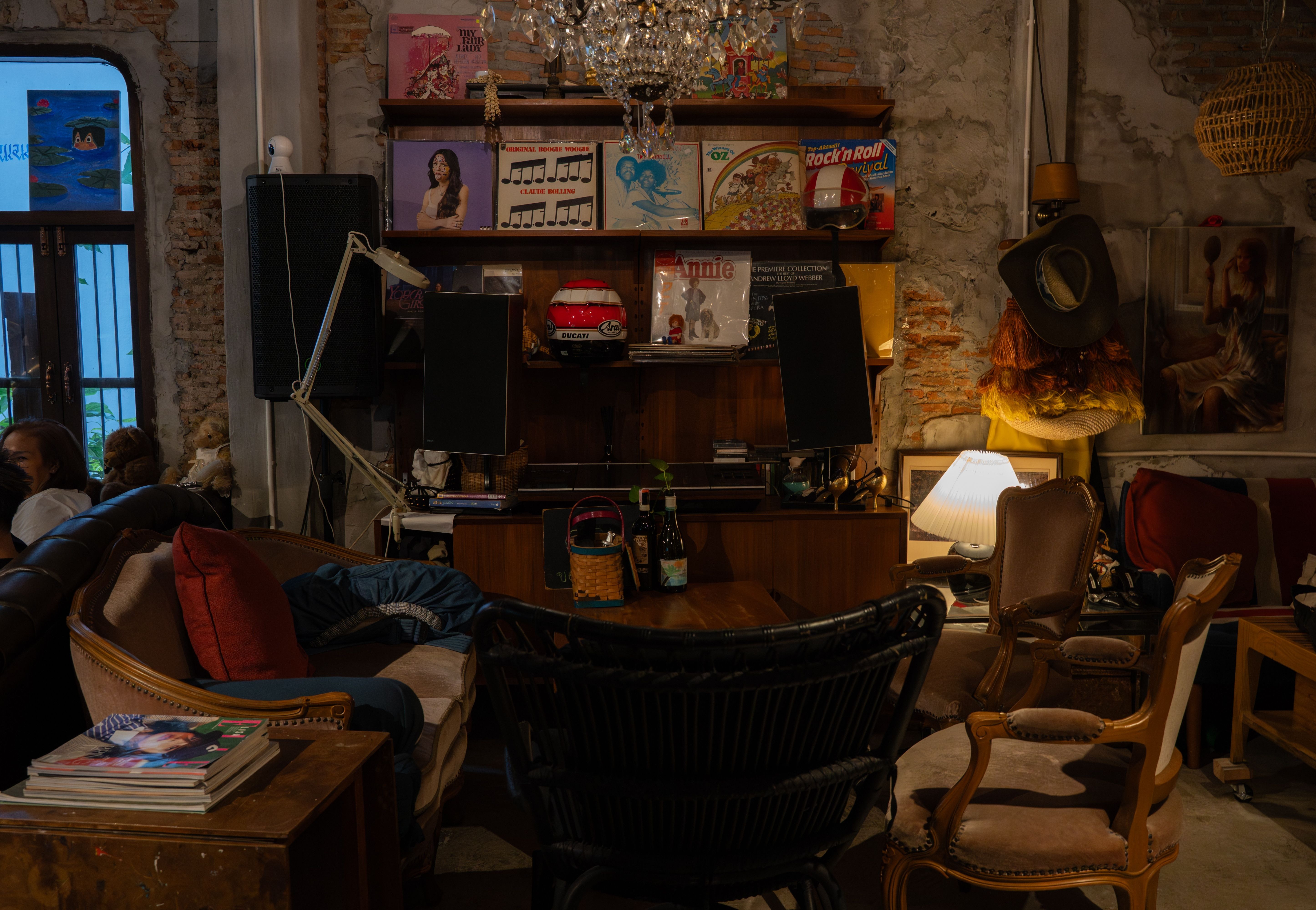 Vintage interior of Camelot Café Bangkok with vinyl records, crystal chandelier, and retro furniture