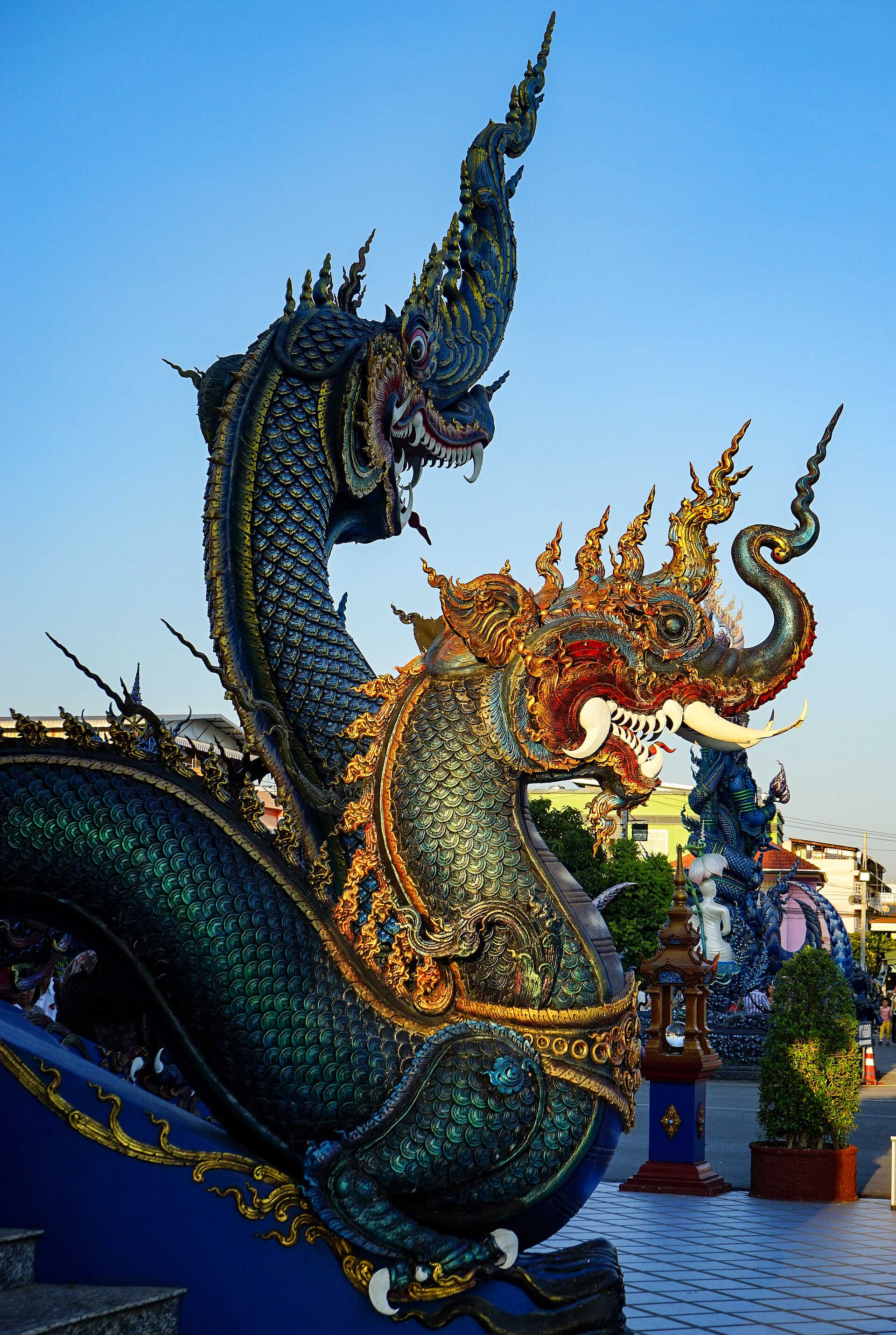Blue naga sculpture on the staircase at Wat Rong Suea Ten