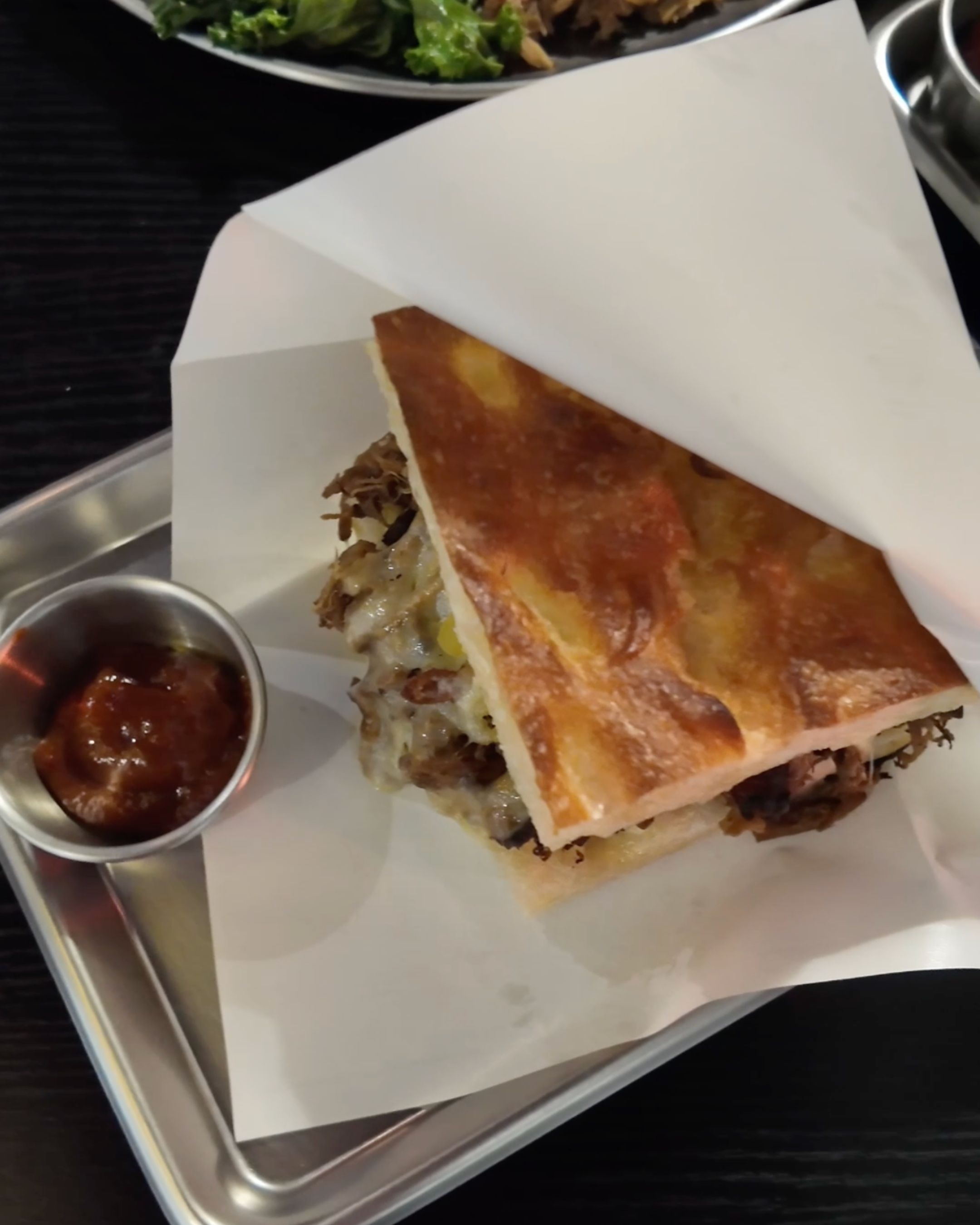 A freshly made sandwich filled with tasty ingredients at Brunch of Idiot.
