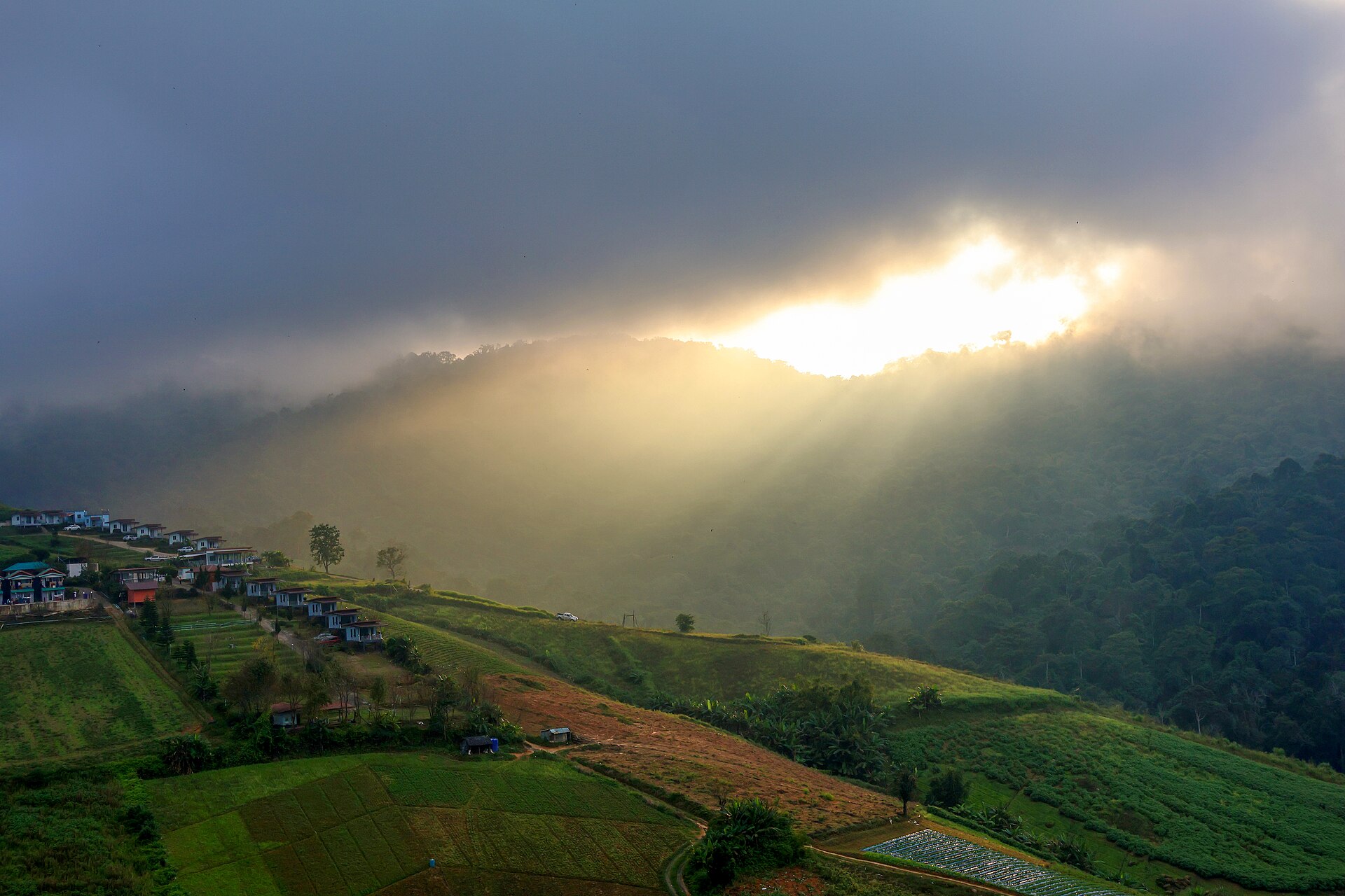 Sunlight breaking through clouds over the farms of Phu Thap Boek, Phetchabun