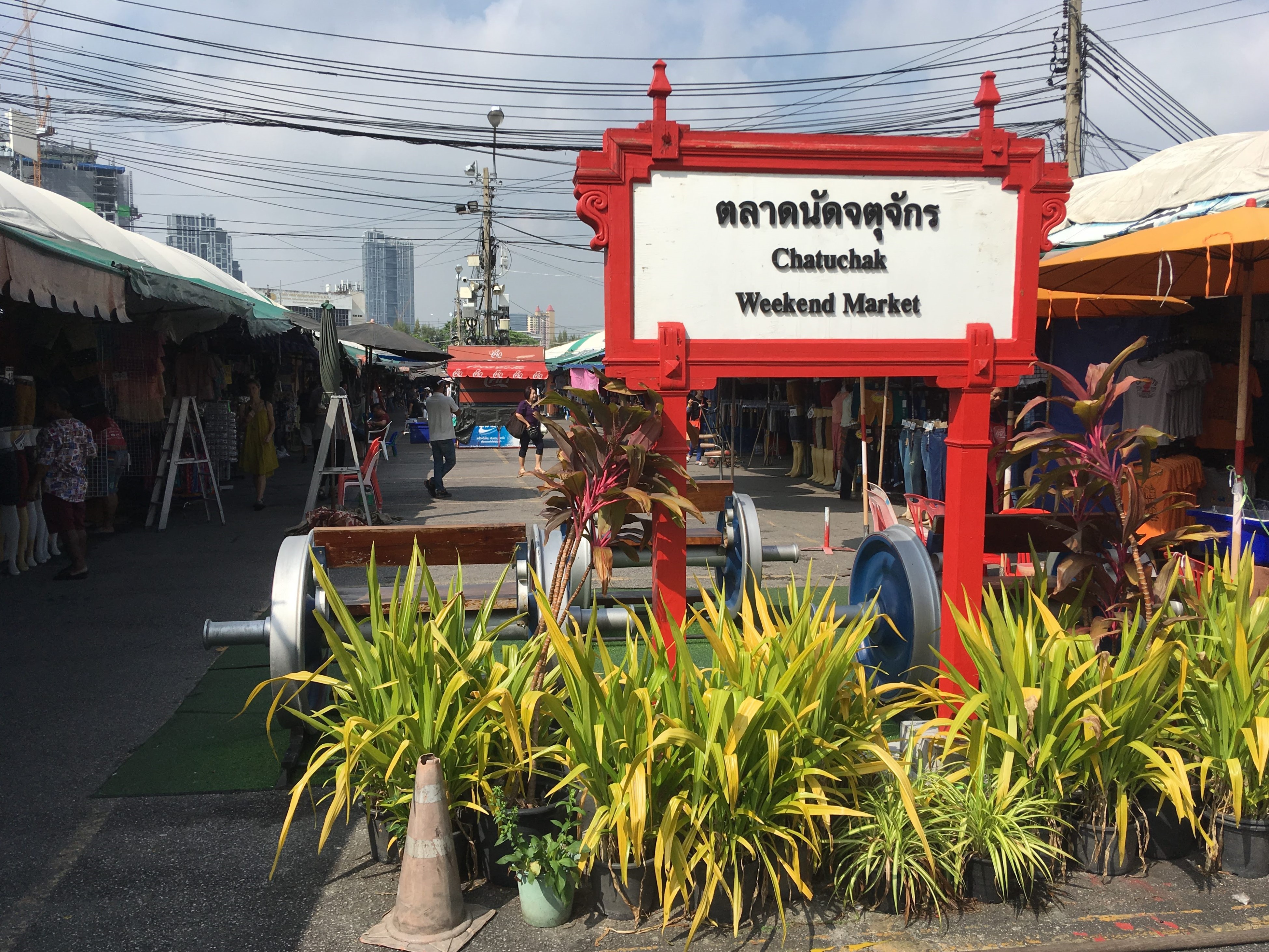 Chatuchak Weekend Market entrance sign and crowded stalls, Bangkok, Thailand