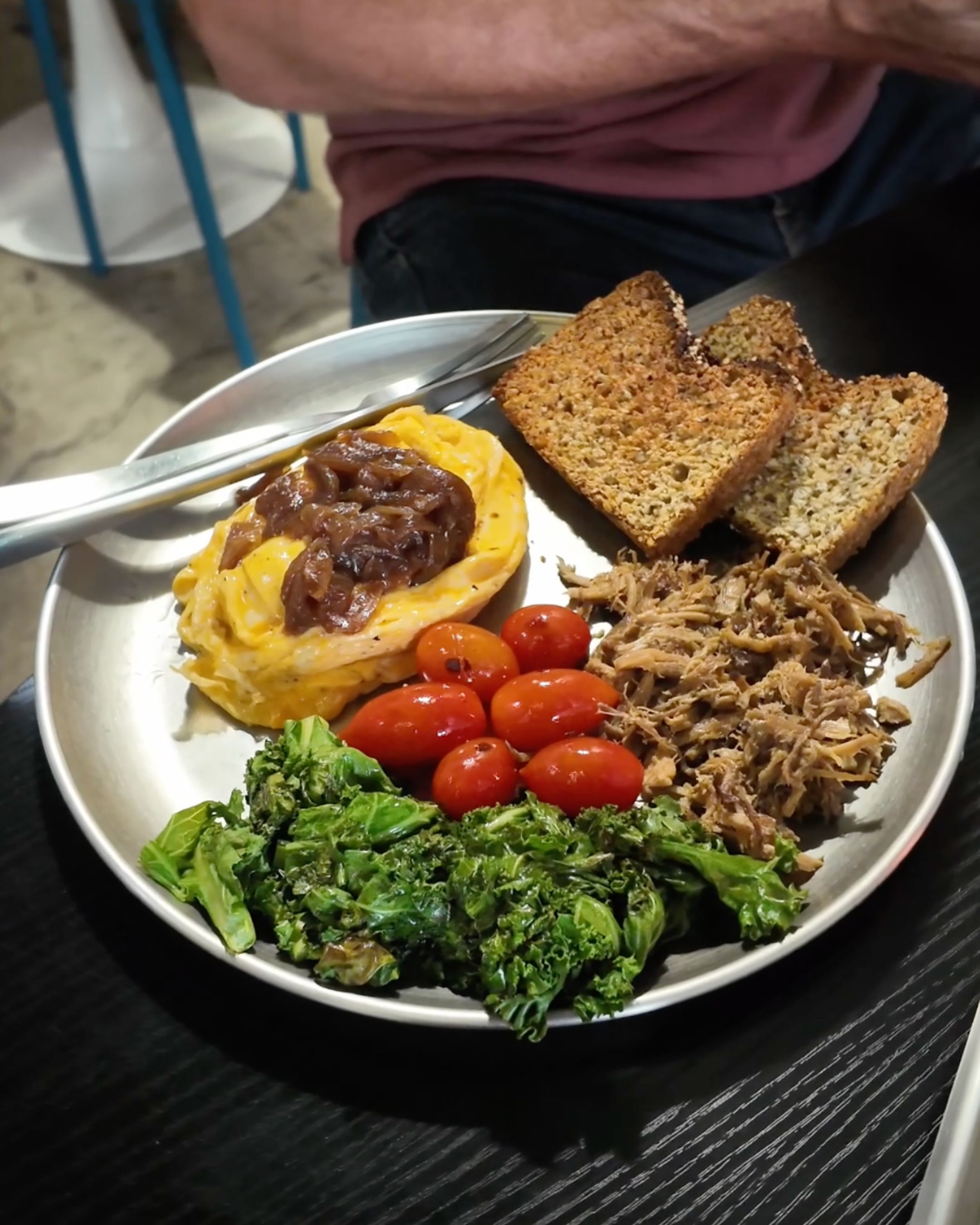 A tasty brunch plate with eggs, fresh vegetables and toast in Bangkok.