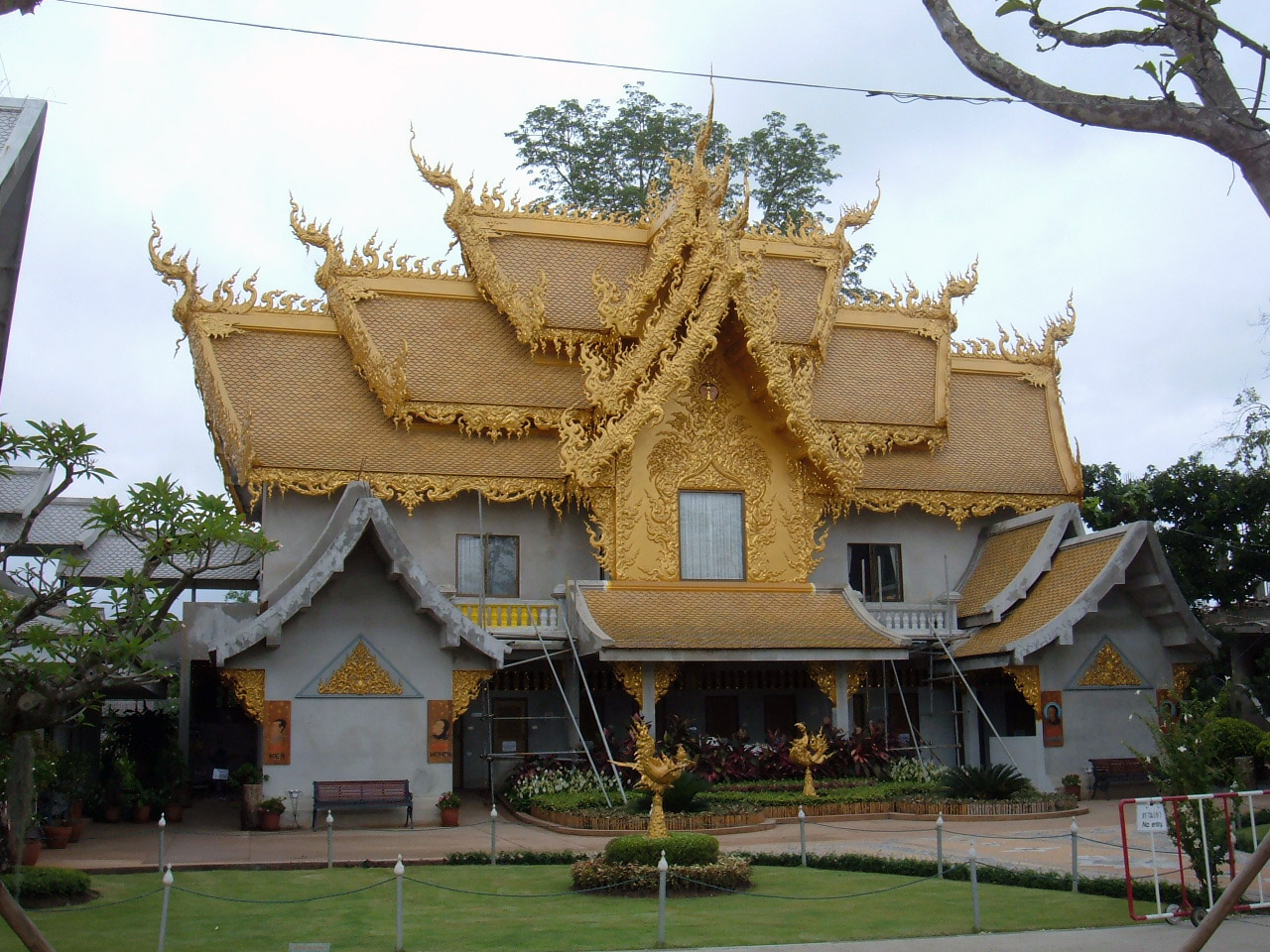 Ornate golden building (restrooms) at Wat Rong Khun White Temple, Chiang Rai, Thailand